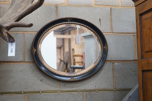 An painted gilt framed oval mirror, width 60cm, height 50cm